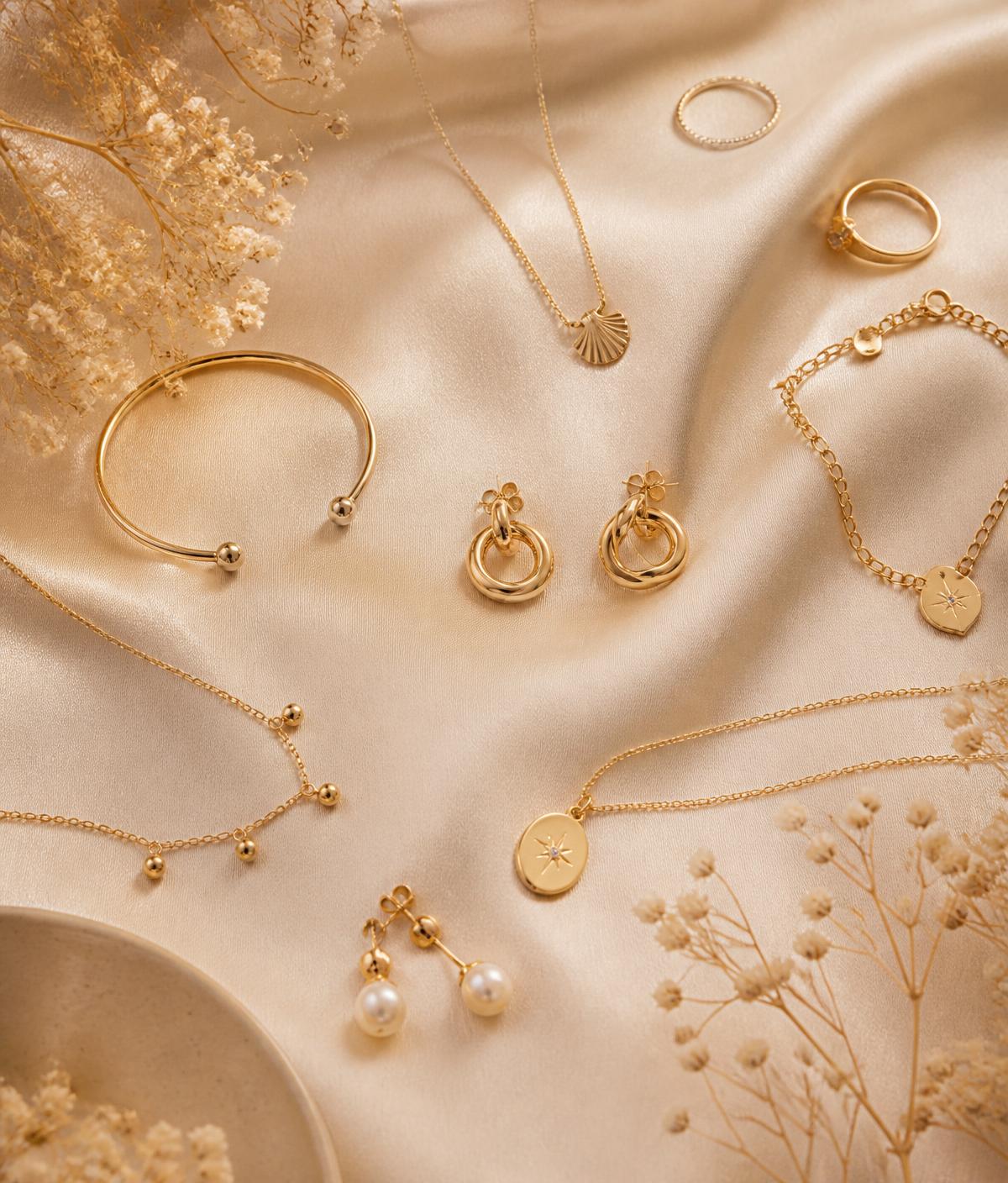 Editorial flat lay of the Nooré jewellery collection on ivory silk