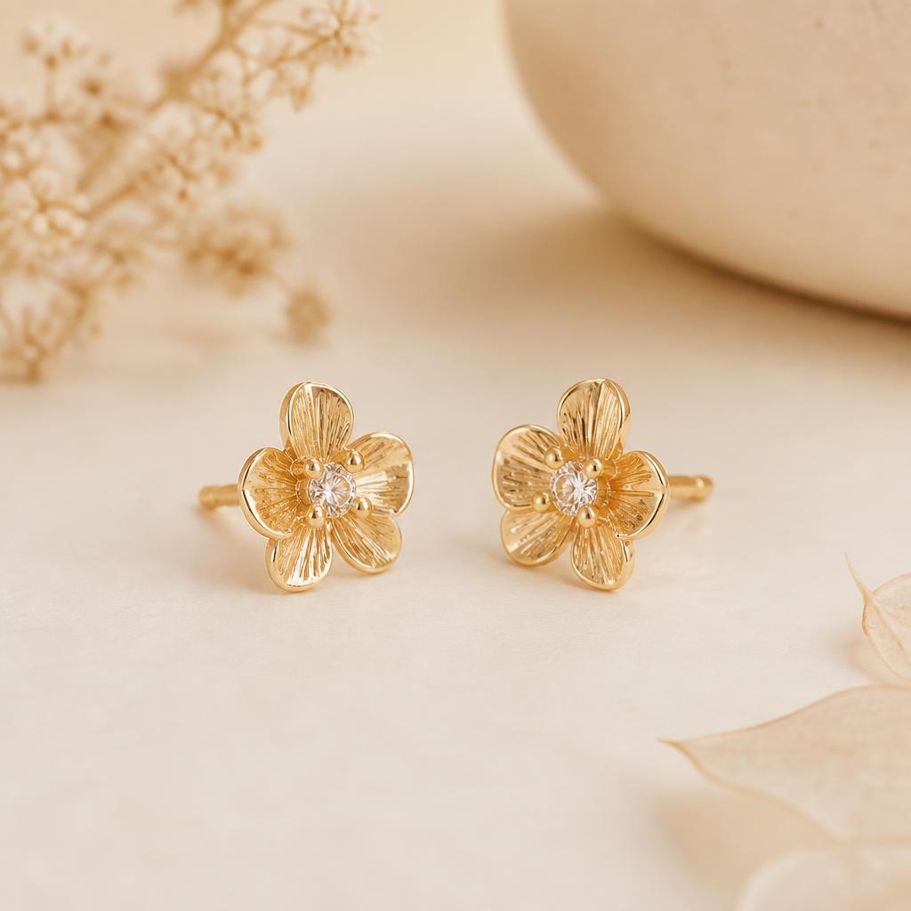 Kavya Floral Studs photographed on a warm ivory background