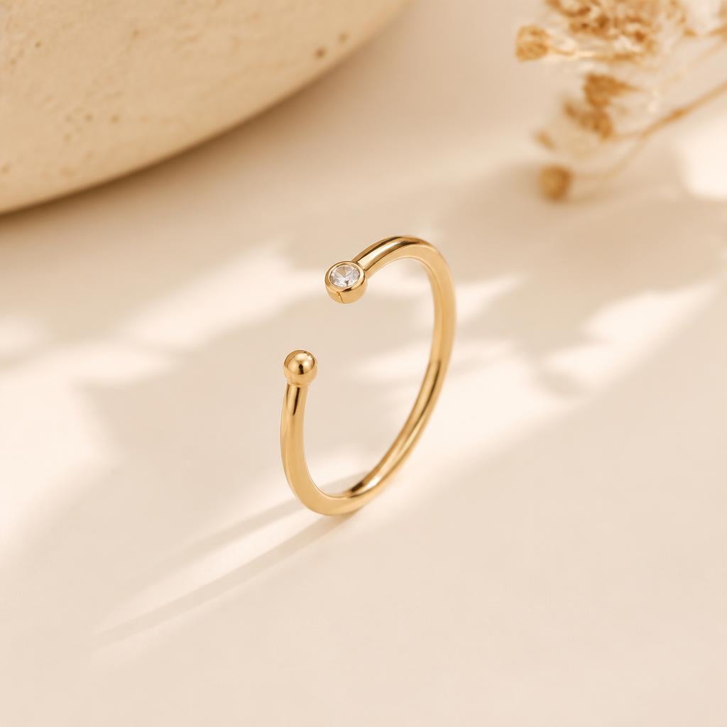 Rhea Adjustable Ring photographed on a warm ivory background
